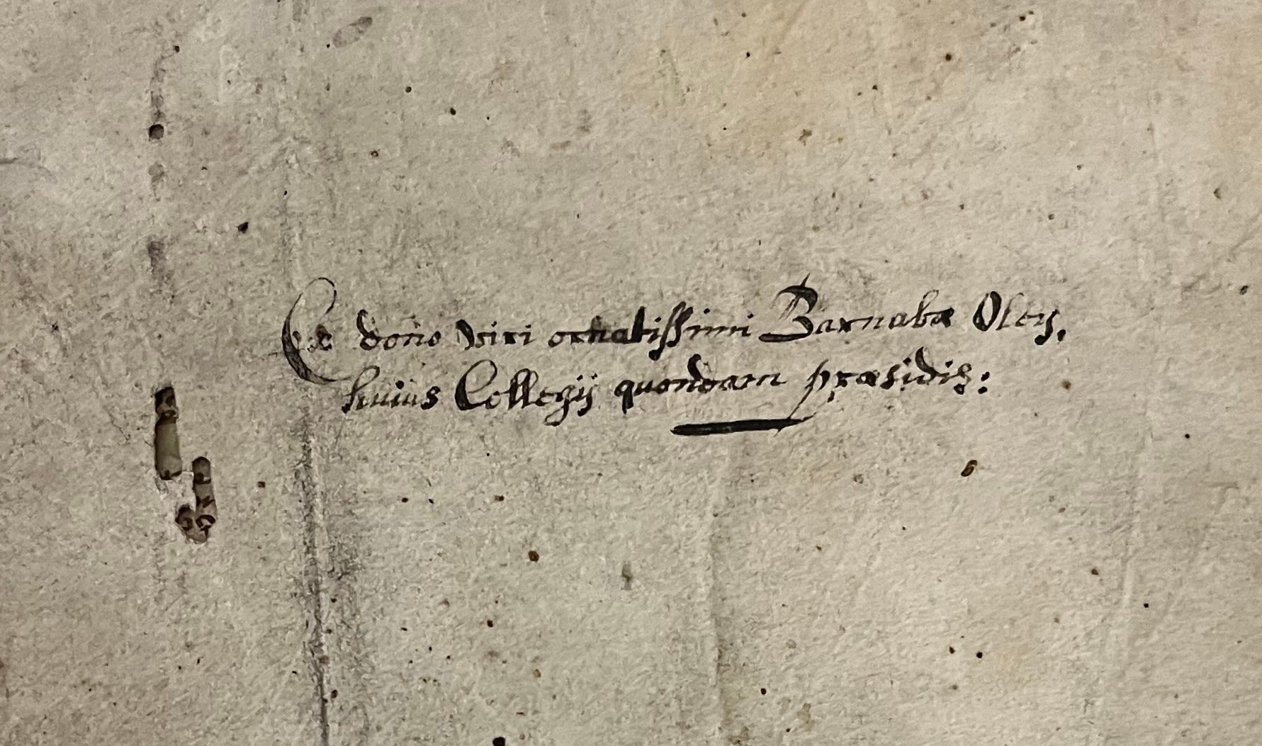 Black ink inscription on stained paper, recording the gift of this book by Barnabas Oley, member of Clare College.